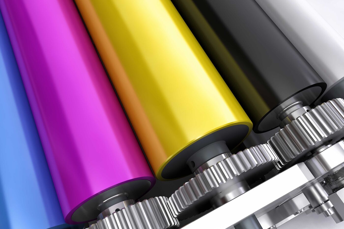 Cilindros revestidos em borracha nas cores magenta, amarelo e preto